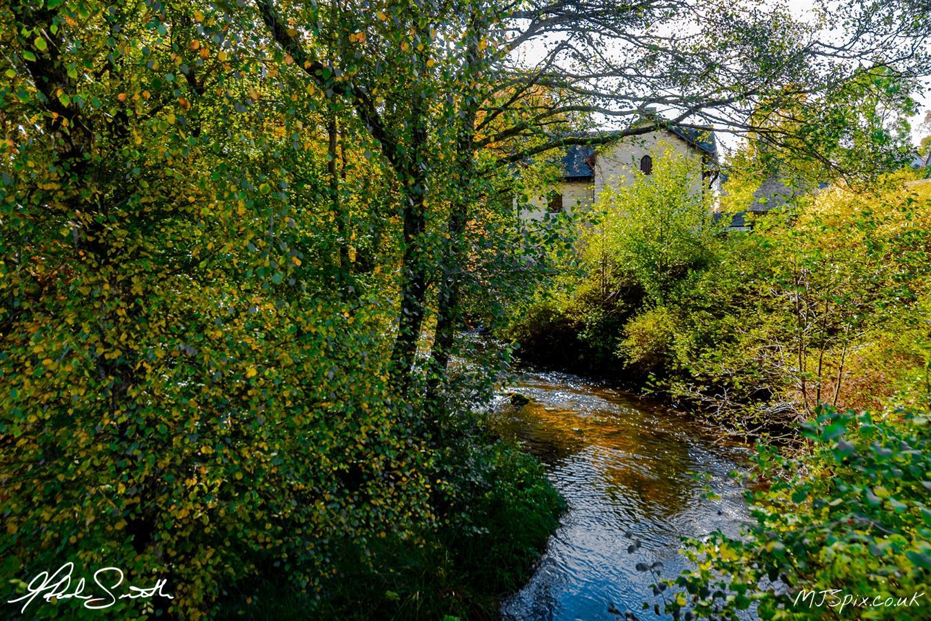 Sunlight through the autumn colours on the tress with the old mill as a backdrop.

Photography by Malcolm J Smith